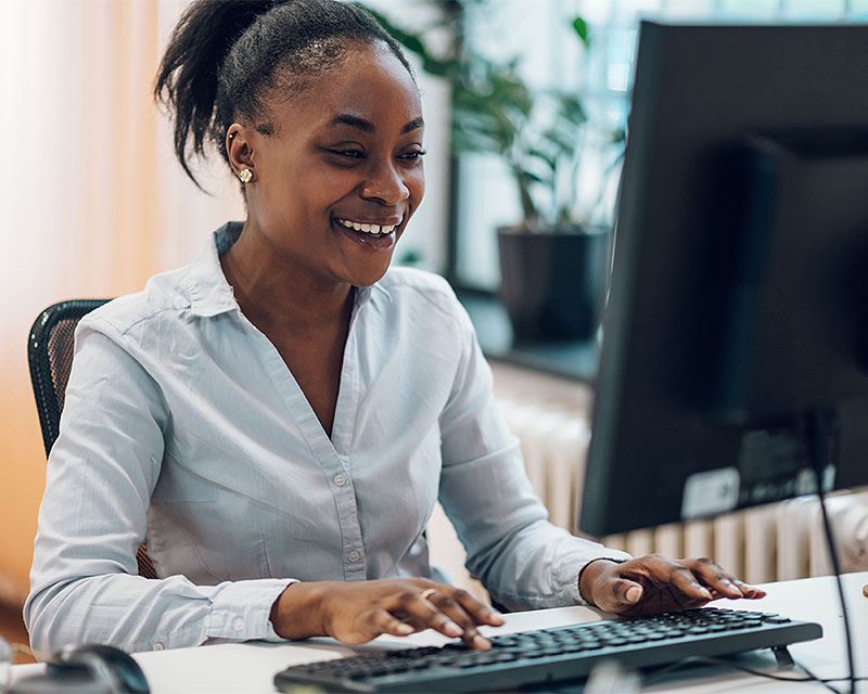 young woman working on desktop computer