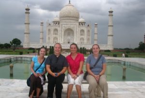 students sitting in front of taj mahal in india