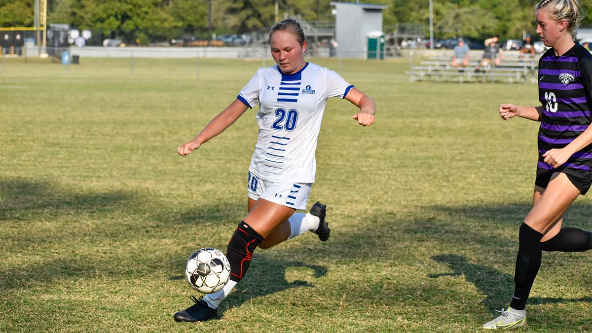 soccer player kicking the ball