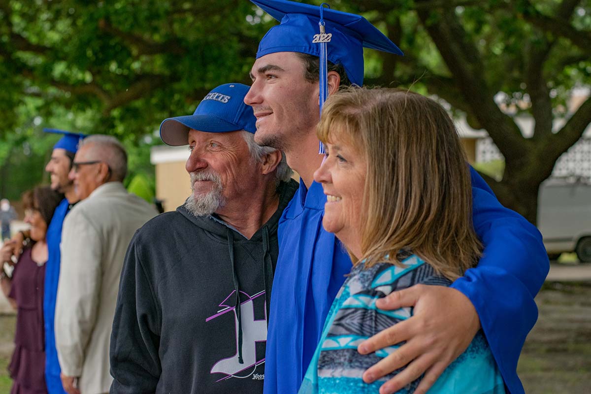 graduating student posing for picture with family