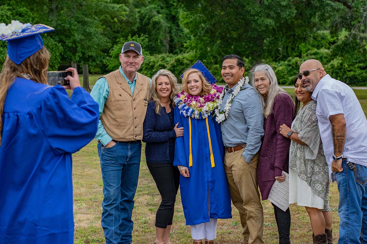 graduating student posing for picture with family