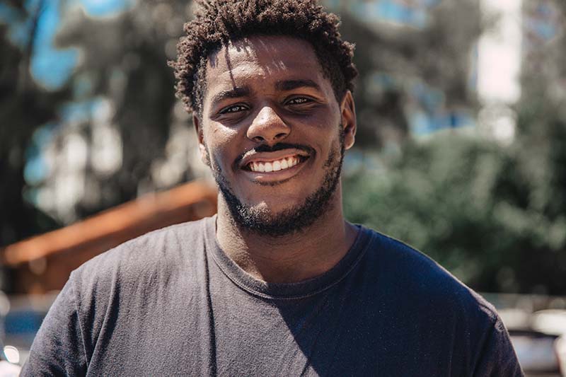 young man smiling at the camera