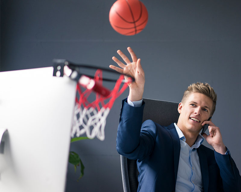 businessman sitting at desk talking on the phone