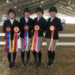 4 SAU equestrian riders holding ribbon awards