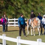 Ride-like-a-night program participants walking through grassy area