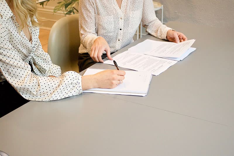 two people filling out paperwork