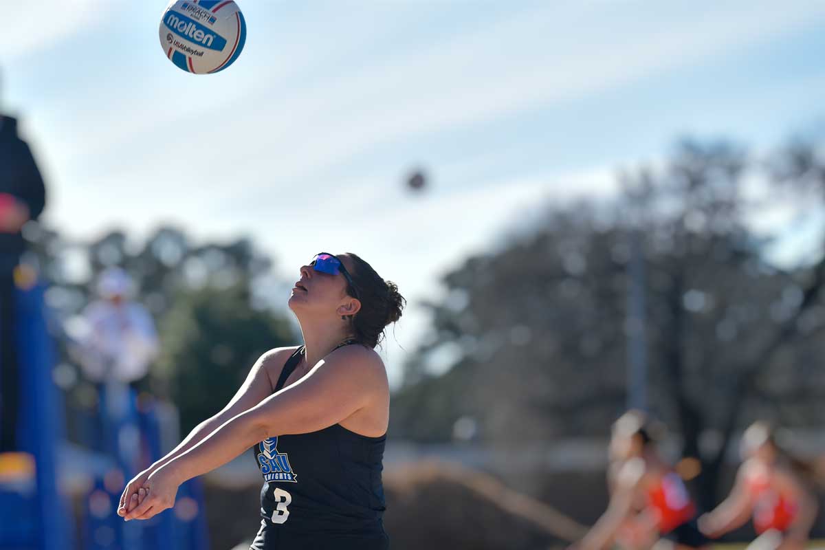 woman's volleyball player hitting the ball