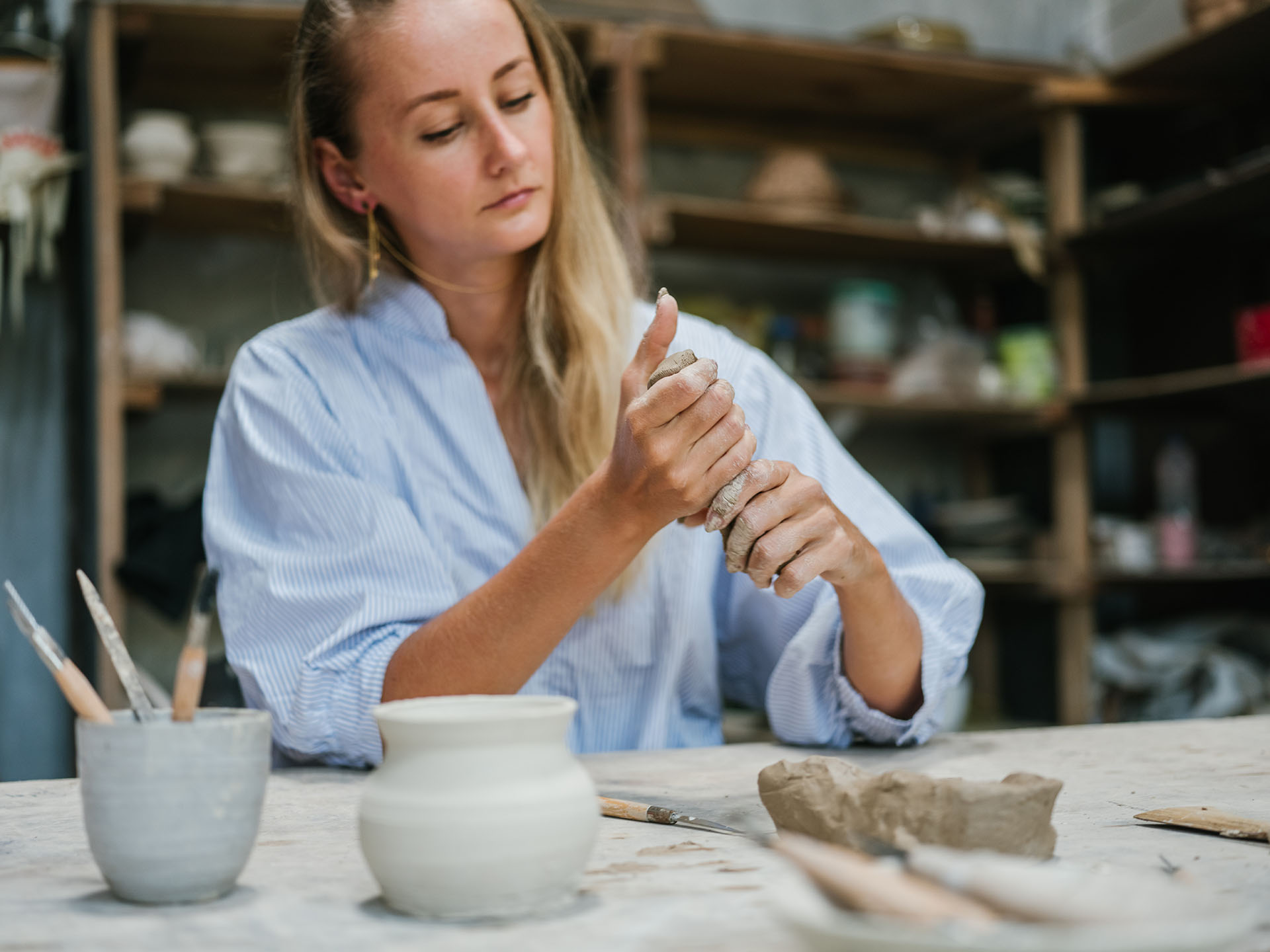 Young woman working with clay